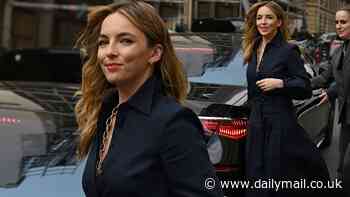 Jodie Comer looks effortlessly classy in a plunging navy blue shirt and midi skirt as she heads to Gabriela Hearst's runway show for Paris Fashion Week