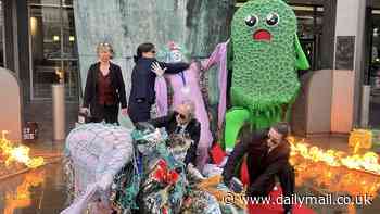 Climate activists don Merfolk outfits and sport a giant green sponge named Scrubby in bizarre protest against corporate 'greenwashing'