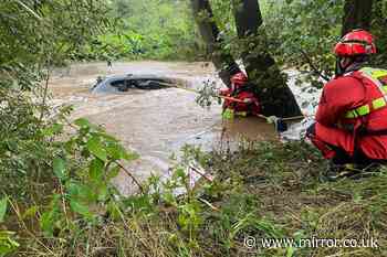 Driver saved by firefighters after car was submerged in water during floods