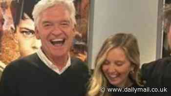 Phillip Schofield looks pleased with himself as he parties with daughter Molly while celebrating his new show Cast Away - despite being blasted by critics and viewers alike