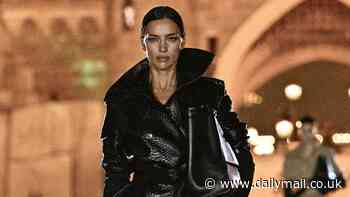 Irina Shayk storms the runway in a chic leather trench coat as she walks in the Coperni show at Disneyland Paris during fashion week