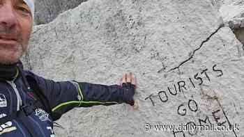 Fury in Italy as world famous rock with dinosaur footprints is defaced with 'tourists go home' graffiti