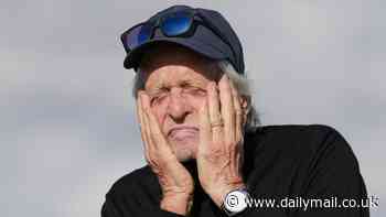 Michael Douglas, 80, gets his head in the game as he cups his face with his hands ahead of teeing off at the Alfred Dunhill golf championship in St Andrews