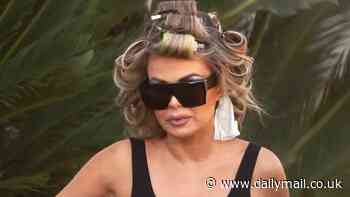 Carmen Electra is downcast with curlers in hair as she surfaces after 'painful' interview