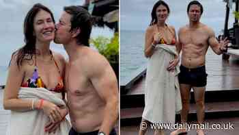 Mark Wahlberg, 53, shows off his very toned body before kissing his bikini-clad wife Rhea Durham in Fiji