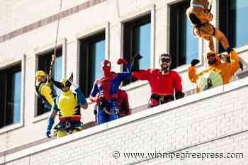 Superheroes, movie characters walk on hospital’s outside walls to brighten young patients’ lives