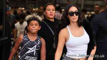 Kim Kardashian struts her stuff in gray sweatpants and a white tank top as she attends her son Saint's basketball game