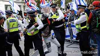 Met make five arrests when protesters clash with police in mass London march on first anniversary of Hamas October 7 attacks - while one banner mocks 'silly sausage' Keir Starmer