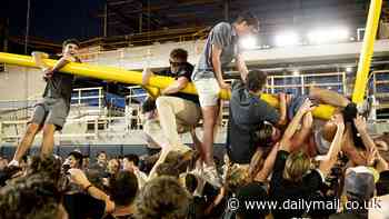 Vanderbilt fans rip down goalposts and dump them in Nashville RIVER following shocking upset over Alabama