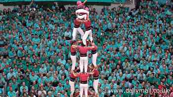 Reach for the sky! Thousands gather for traditional Spanish Castells competition to form the tallest human tower