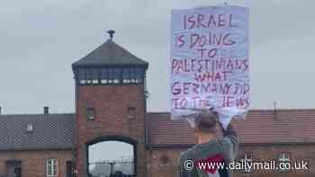 Fury as Polish artist stands outside Auschwitz with sign saying 'Israel is doing to Palestinians what the Germans did to Jews' four days before October 7 anniversary