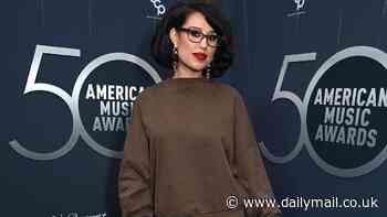 Worst dressed! Raye dresses down in baggy sweater and bold mini skirt alongside Sophia Culpo as they lead fashion fails at the American Music Awards 50th Special