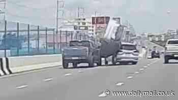 Instant karma! Dangerous driver's Honda flips off flyover after trying to squeeze between two vehicles, crashing into them and losing control