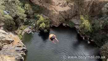 Stomach-churning moment French daredevil breaks world 'death diving' record with 144ft leap into water from cliff edge in Spain