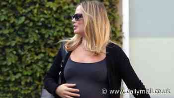 Margot Robbie shows off baby bump in form-fitting black dress... after Wuthering Heights controversy