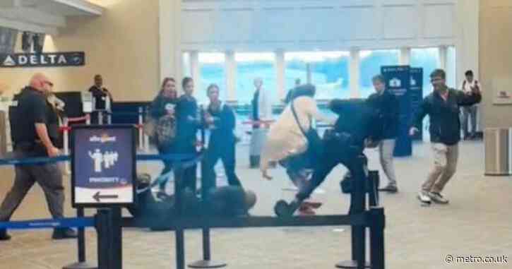 Moment airline customer jumps behind check-in counter and threatens to ‘kill’ cops