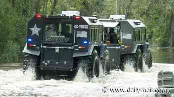 Rescue crews use all-terrain vehicles to visit homes after floods savaged Tampa during Hurricane Milton