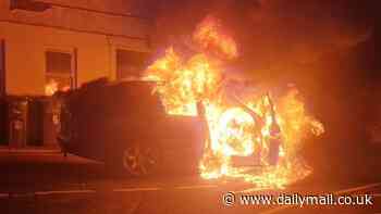 Moment car bursts into huge fireball on busy high street in front of shocked locals