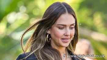 Jessica Alba shows a hint of midriff in crop top and baggy blue jeans for meeting at The Beverly Hilton Hotel