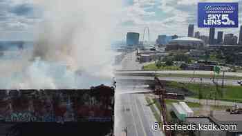 Historic warehouse catches fire weeks after owner sought police protection from homeless trespassers; billowing smoke shutters Stan Musial Bridge