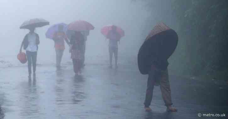 The wettest place on Earth where homes are built on stilts and people carry full-body brollies