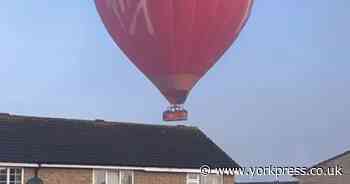 WATCH: Hot air balloon spotted ‘just clearing’ roofs of houses in York town