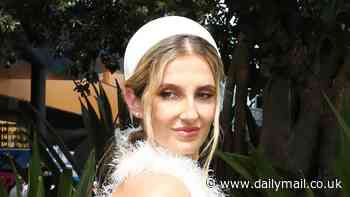 Kate Waterhouse shows off her quirky sense of style in an elegant feathered gown at the Royal Randwick's Everest race day in Sydney