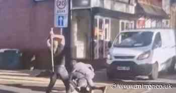 Horrifying moment men batter each other with metal poles in the middle of the road