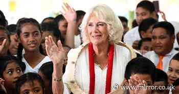 Queen Camilla beams and taps her feet as she watches village children sing