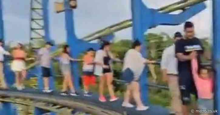 Terrified rollercoaster passengers walk down tracks after ride halts 70ft in air