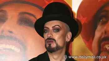 Boy George looks typically stylish in all black as he is joined by Lizzie Cundy who puts on a busty display at the launch of the singer's limited edition art collection