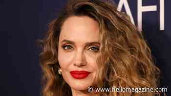 Angelina Jolie rocks figure-hugging liquid gold dress and tumbling curls