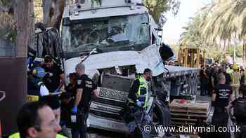 Man killed and dozens injured as truck rams into crowded bus stop near Mossad headquarters in Israel before driver shot dead by civilians - as Hamas praises terror attack