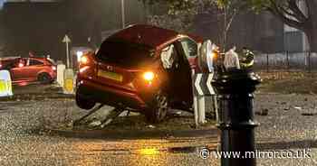 Car left dangling from traffic signs on roundabout after horror crash