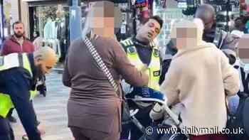 Moment women pushing a baby in their pushchair and friend holding a teddy bear are stopped by security and busted for suspected shoplifting