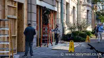 Store windows are boarded and cops brace for election riots as red-hot America heads to the polls