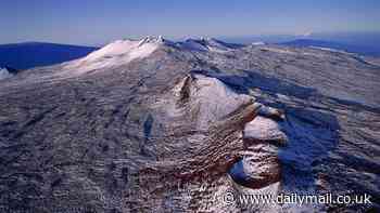 Hawaii summit blanketed in snow in rare cold snap