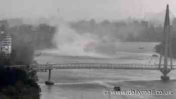 'Mini tornado' sweeps across Brisbane River as Queensland is battered by wild thunderstorms and huge hail