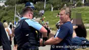 Provocative anti-Israel T-shirt sees man arrested on Australia's most iconic beach