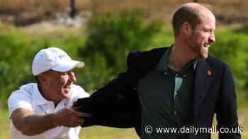 Prince William shows off his rugby skills and is tackled by Springbok legend Joel Stranksy during visit to South African township