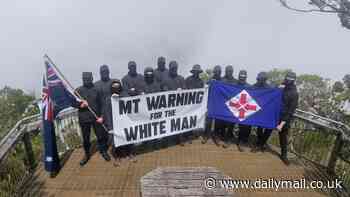 White supremacists condemned after neo-Nazi flag unfurled on sacred Indigenous mountain in vile protest - as row erupts over who is allowed to climb it