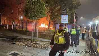 Yobs clash with riot police and hurl fireworks at emergency services as Bonfire Night trouble flares across UK