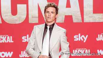 Eddie Redmayne resembles John Travolta in Saturday Night Fever as actor pulls on a white flared suit for the Berlin premiere of The Day Of The Jackal