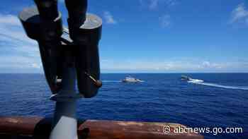 Philippine forces retake an island in mock combat as China's navy watches