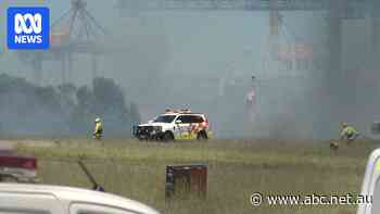 Live: Qantas plane makes emergency landing at Sydney Airport amid grassfire near runway