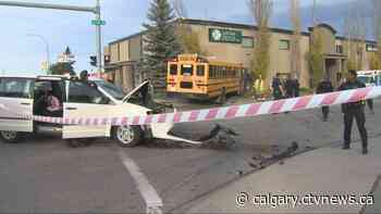 Minivan and school bus collide in northeast Calgary intersection, causing bus to hit building