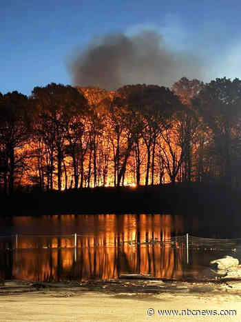 Wildfires rage across the Northeast amid warm, dry conditions