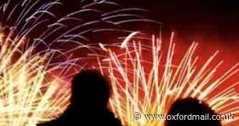 Silhouettes at sparkling fireworks display is top photo