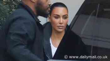 Kim Kardashian sports edgy black trench coat as she visits skin care clinic in Beverly Hills