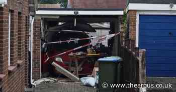 Person rescued after car ploughs into garage